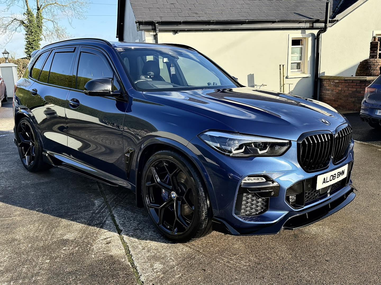 Close-up of a blue BMW X5 with clear paint reflections